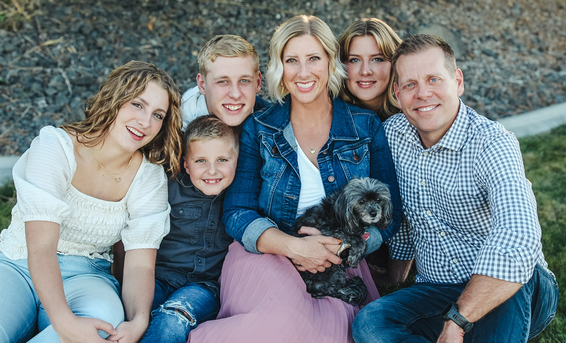 Dr. Barney and family smiling together outdoors