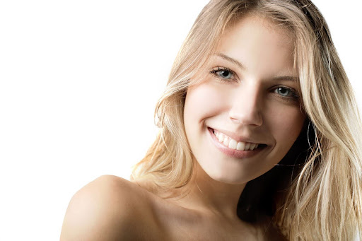 woman smiling who receives preventative dental care