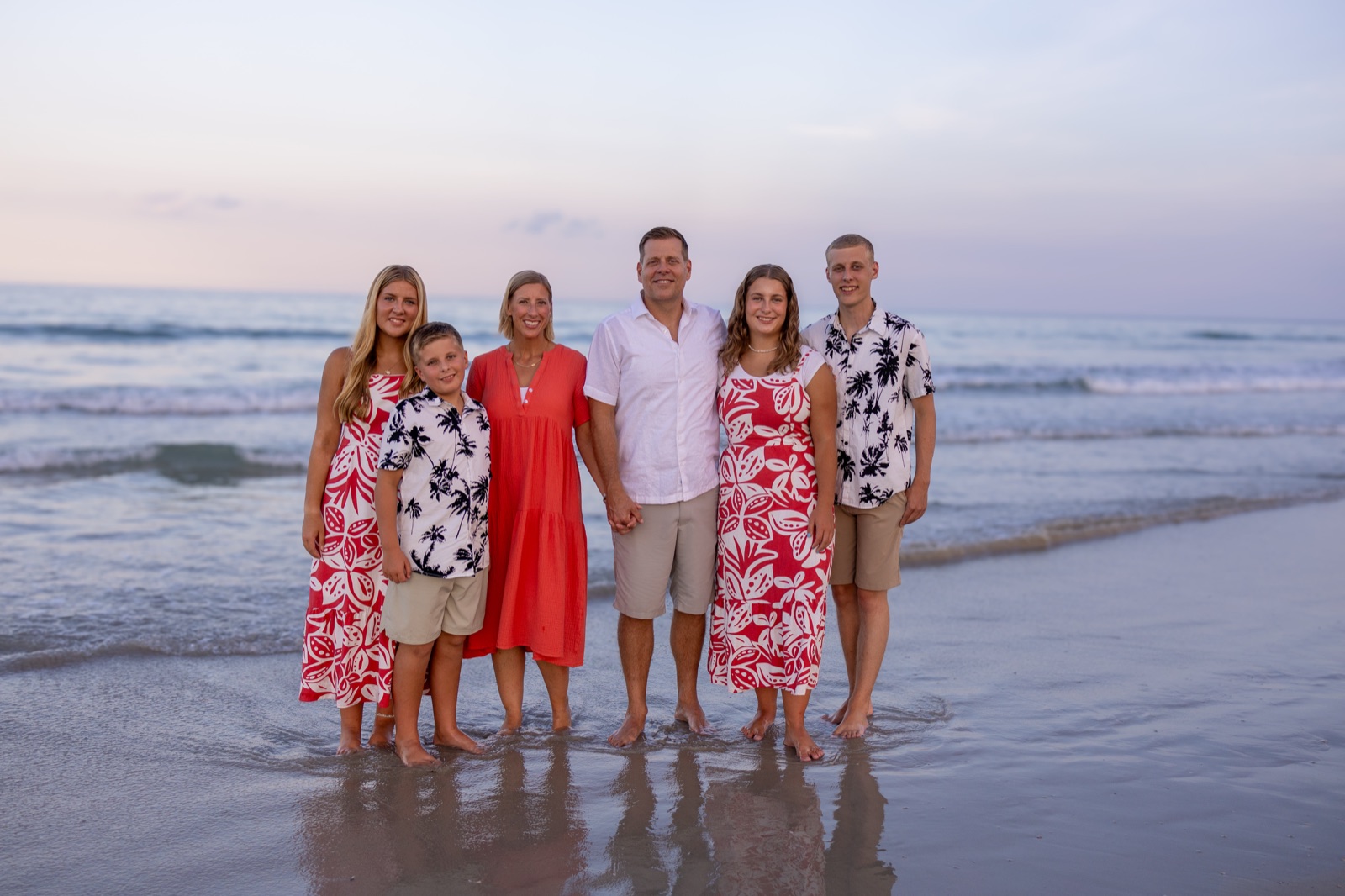 Dr. Craig Barney of DeLand Family Dental with his wife, Brooke, and their four children on the beach at sunset